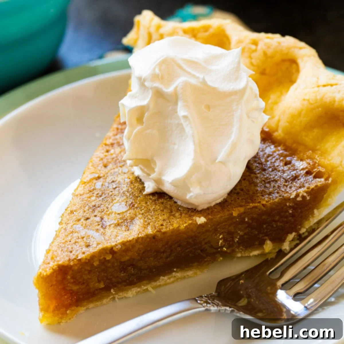 Decadent Caramel Chess Pie 2 A beautiful slice of Caramel Chess Pie, topped with a generous swirl of fresh whipped cream, ready to be enjoyed.