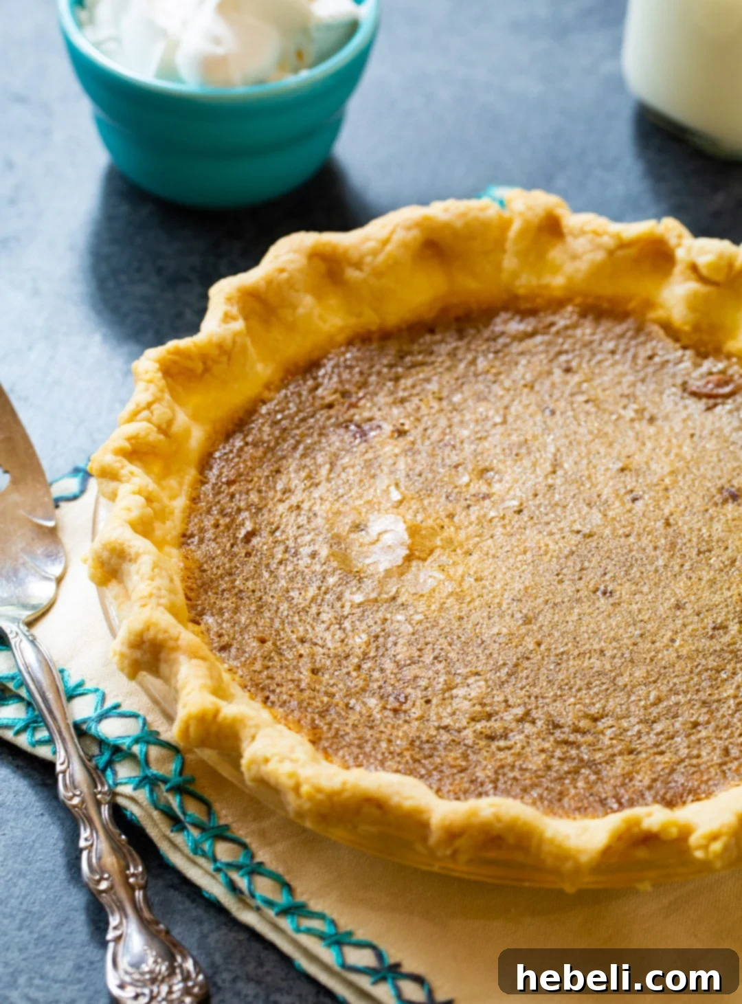 Decadent Caramel Chess Pie 3 A freshly baked Caramel Chess Pie, whole and glistening, resting in its pie plate, ready to be cooled and sliced.