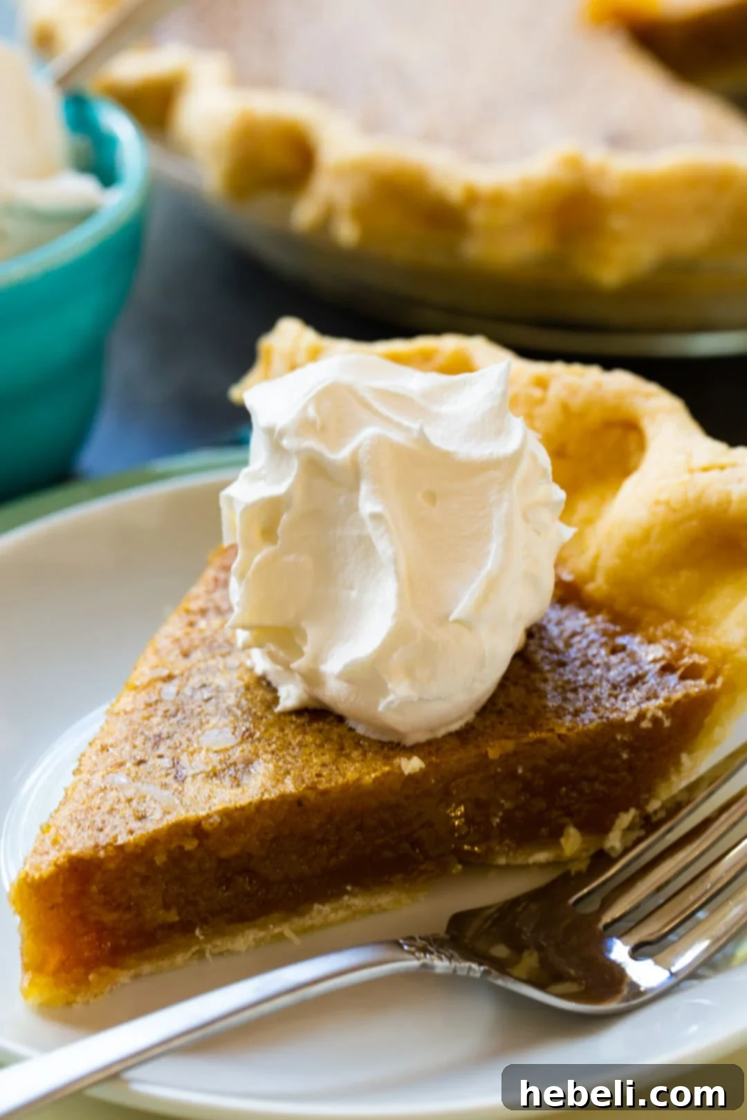 Decadent Caramel Chess Pie 4 A close-up of a slice of Caramel Chess Pie, generously crowned with fluffy whipped cream, highlighting its inviting texture and golden crust.