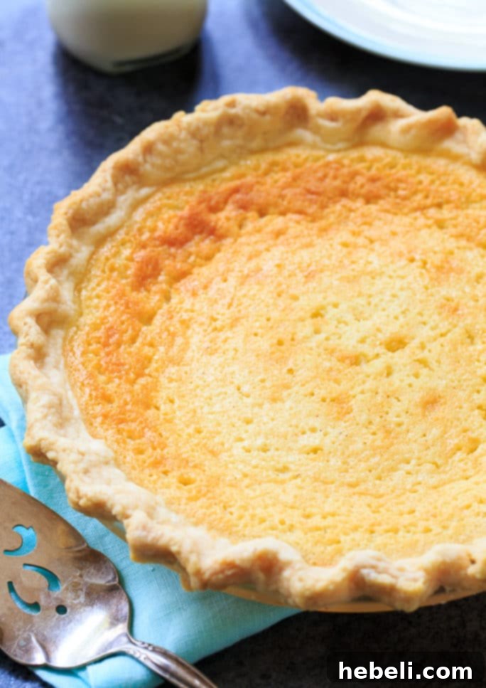 Close-up of a slice of Old-fashioned Buttermilk Pie, showcasing its creamy custard filling