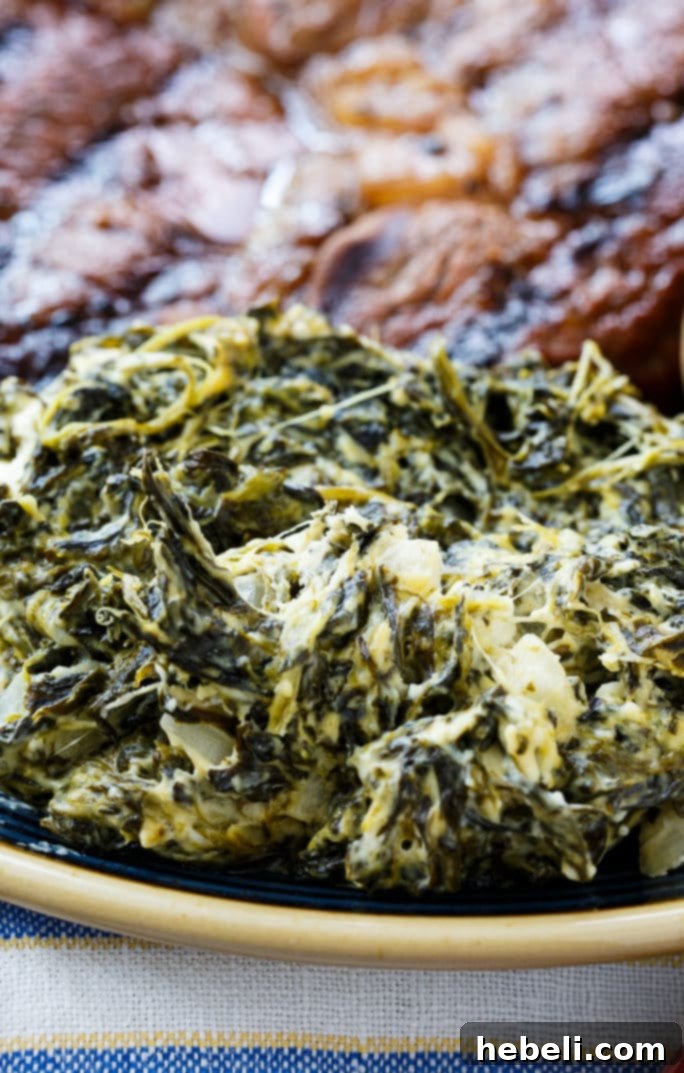 Served Slow Cooker Jalapeno Creamed Spinach with a spoon