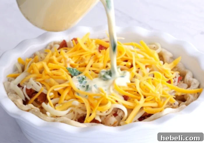 Pouring the egg and half-and-half mixture over the quiche filling in the crust.