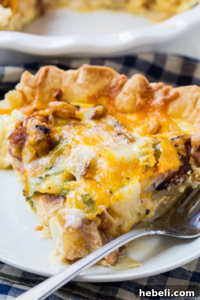 Farmhouse Bacon Potato Quiche 12 A slice of Bacon and Potato Quiche served on a plate with a side salad.