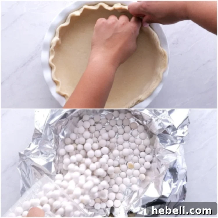 Blind baking a pie crust with foil and pie weights.
