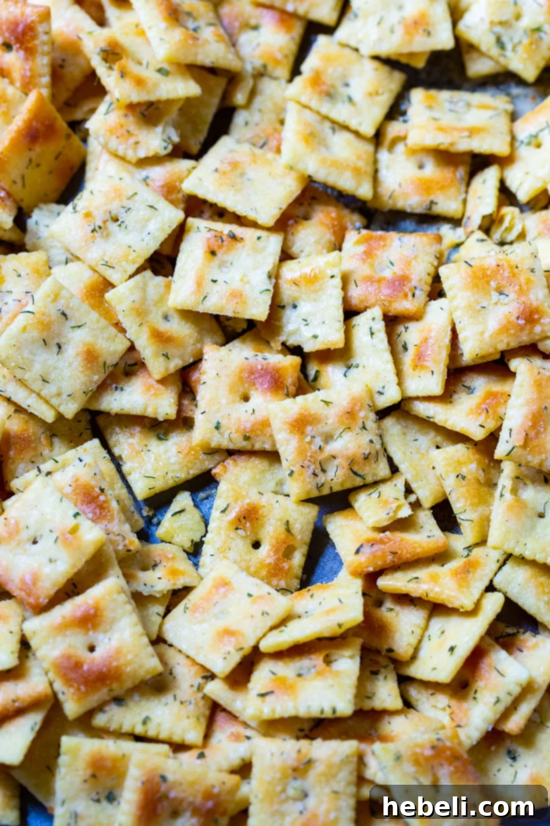 Zesty Ranch Cheez-Its 3 Freshly seasoned Cheez-Its spread evenly on a baking sheet, ready for the oven.