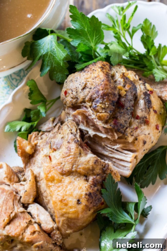 Slow Cooker Pork Loin with savory gravy, served on a rustic plate