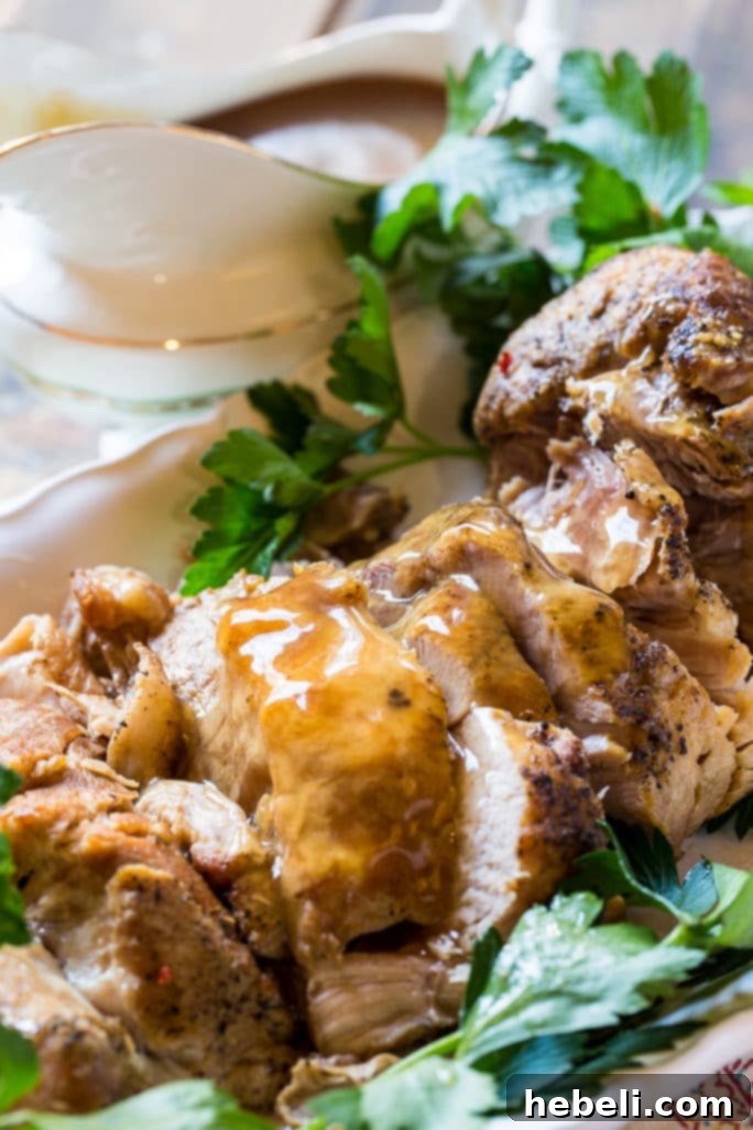 Crock Pot Pork Loin sliced and covered in rich gravy, ready for serving