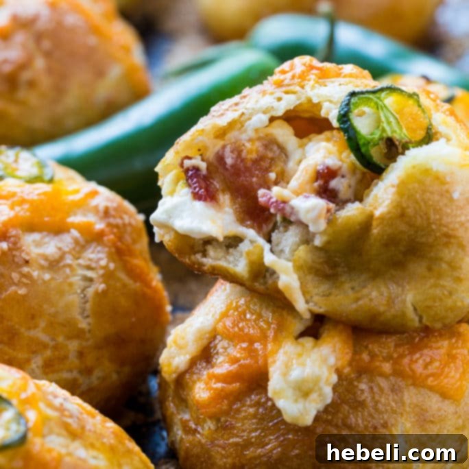 Deliciously golden-brown Jalapeno Popper Stuffed Pretzel Rolls, ready to be devoured