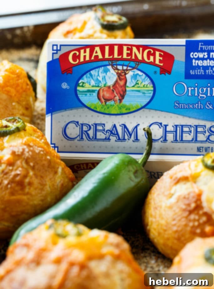 Pretzel dough being wrapped around the jalapeno popper filling, showing the stuffing process