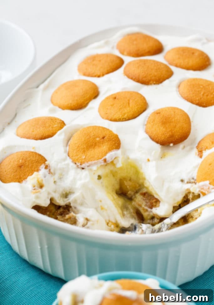 A large serving of Bananas Foster Banana Pudding, ready to be enjoyed.
