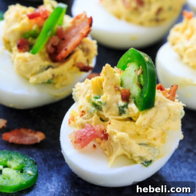 Jalapeno Popper Deviled Eggs, a spicy and creamy appetizer with bacon bits.