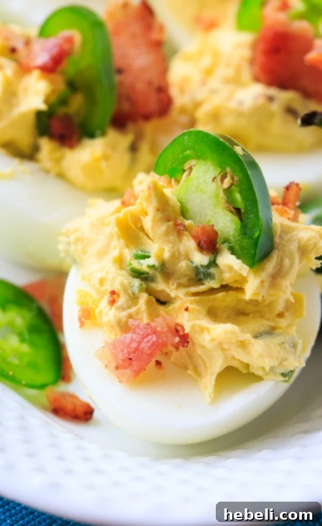 Ingredients for Jalapeno Popper Deviled Eggs laid out on a cutting board.