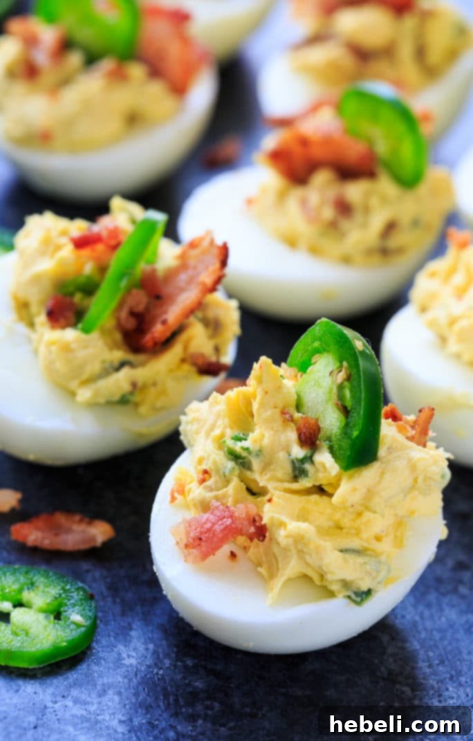 Plating Jalapeno Popper Deviled Eggs, showing the filling process.