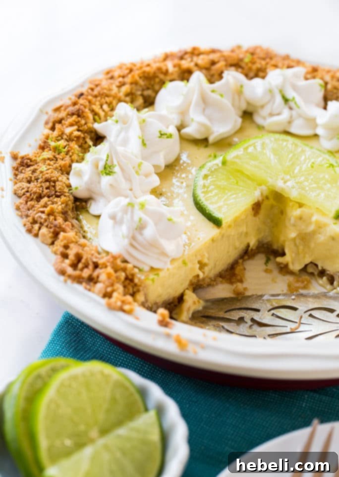 Close-up of a slice of Lime Pie with Coconut Macadamia Crust, showing layers