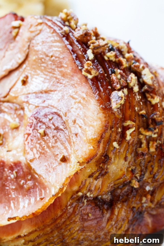Praline Glazed Ham on a serving platter surrounded by various delicious side dishes