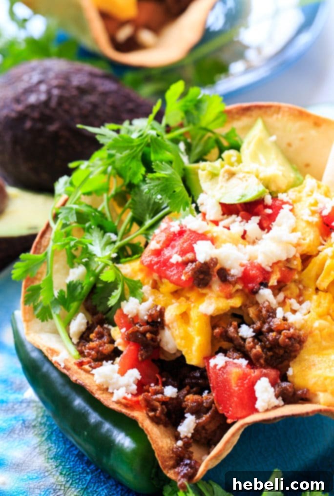 Spicy Chorizo Ranchero Skillet 6 A close-up of a finished Chorizo and Eggs Ranchero in a tortilla bowl, ready to eat.