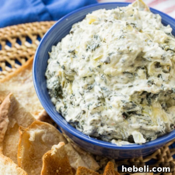 Creamy Crock Pot Spinach Artichoke Dip 2 Delicious Crock Pot Spinach Artichoke Dip in a slow cooker, ready to serve