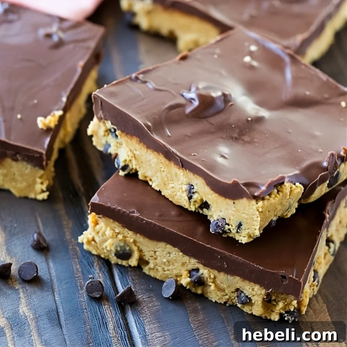 Effortless Chocolate Peanut Butter Squares 2 Delicious No-Bake Chocolate Peanut Butter Bars cut into perfect squares, ready to be served.