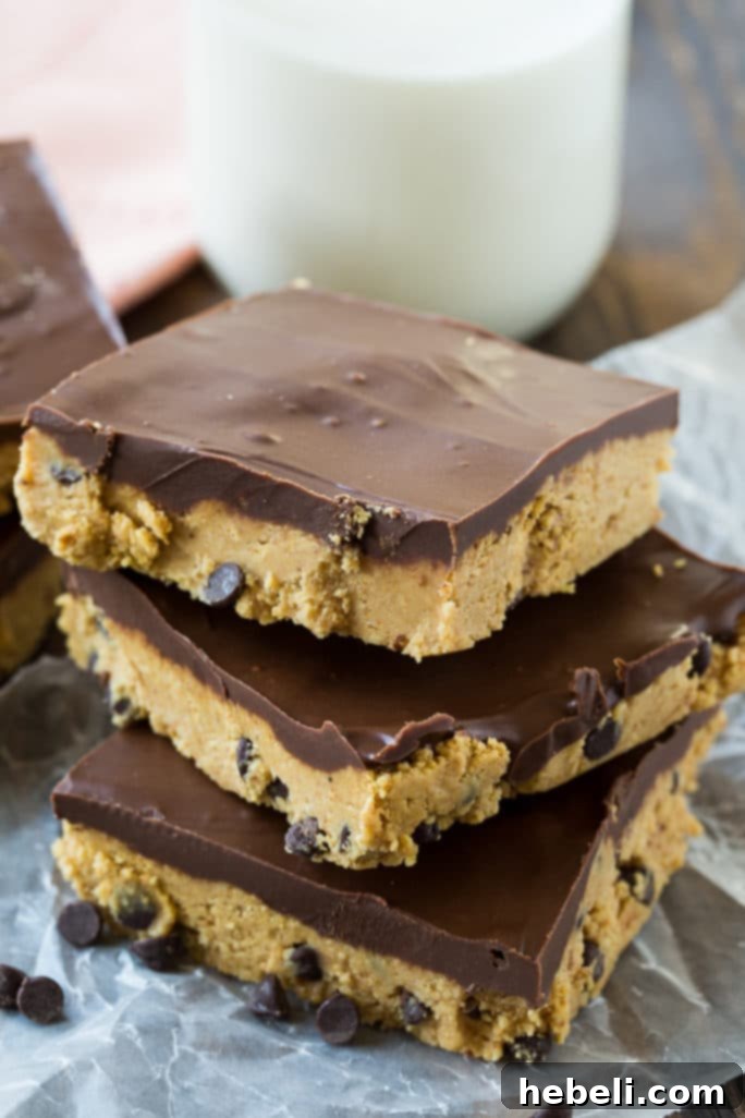 Effortless Chocolate Peanut Butter Squares 4 A stack of No-Bake Chocolate Peanut Butter Bars on a white plate.
