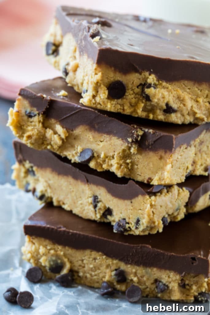 Effortless Chocolate Peanut Butter Squares 5 A slice of No-Bake Chocolate Peanut Butter Bar with a bite taken out, showing the rich layers.