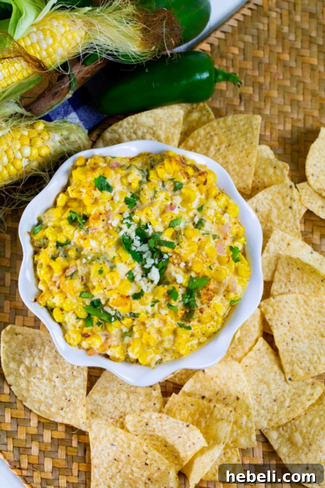 An inviting overhead shot of the creamy, cheesy Mexican Street Corn Dip, garnished with fresh herbs and ready for dipping.
