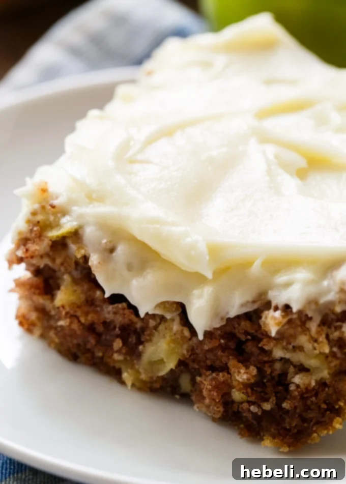 Homestyle German Apple Cake 3 Top-down view of a whole German Apple Cake generously covered with smooth cream cheese frosting, ready to be served.