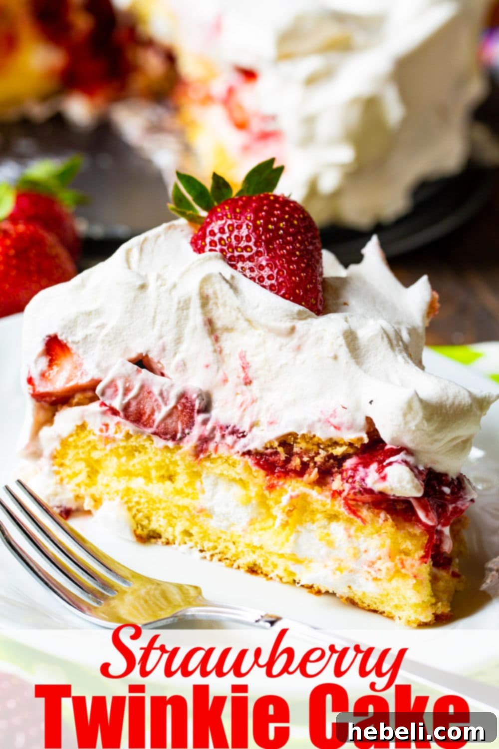 A vibrant, close-up shot of the Strawberry Twinkie Cake, showcasing the rich layers of golden cake, creamy white filling, and bright red strawberries, ready to be devoured.
