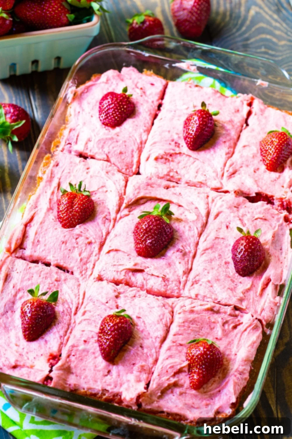 Perfect Strawberry Sheet Cake 3 A freshly baked Strawberry Sheet Cake, perfectly cut into uniform squares, nestled in a baking pan, ready to be served or frosted.