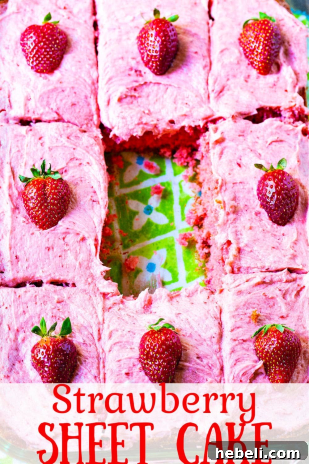 A Strawberry Sheet Cake, with one piece thoughtfully removed from the center, showcasing its inviting texture and the generous layer of pink frosting.