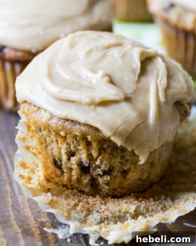 A beautiful display of Zucchini Cupcakes with Caramel Frosting, some with chocolate chips visible