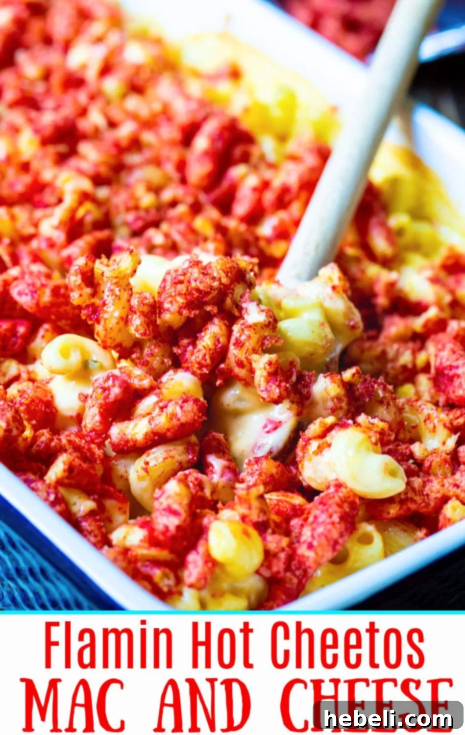 A vibrant, close-up shot of Flamin' Hot Cheetos Mac and Cheese served in a rustic bowl, steam rising.