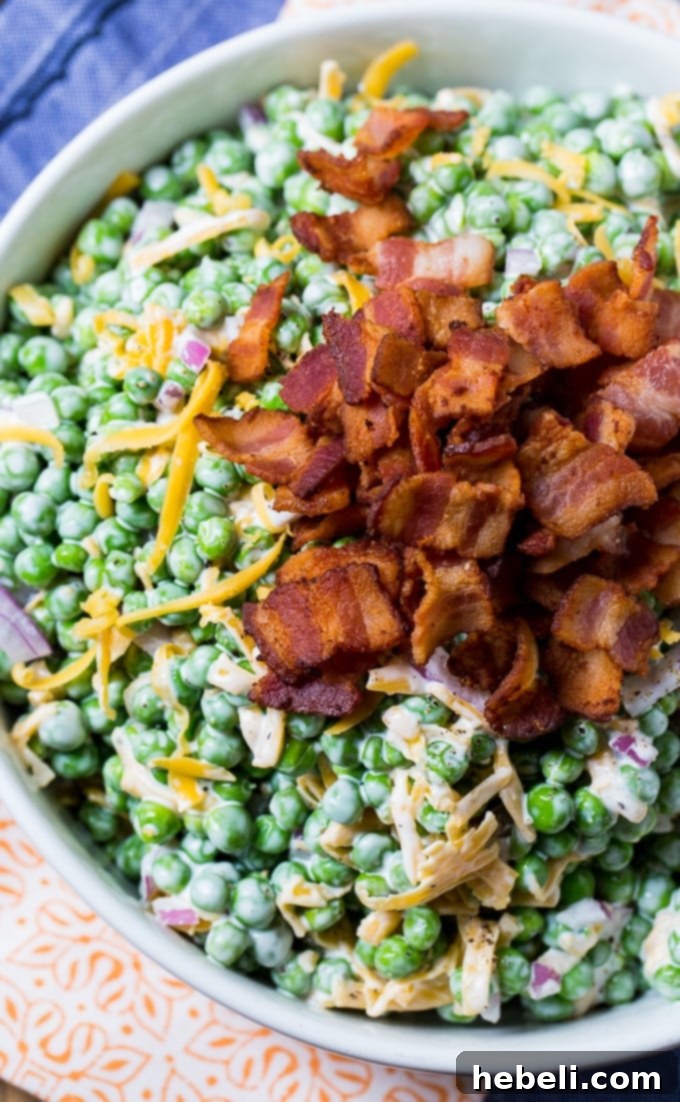 A close-up of Creamy Pea Salad in a rustic bowl, showcasing its vibrant color and texture.