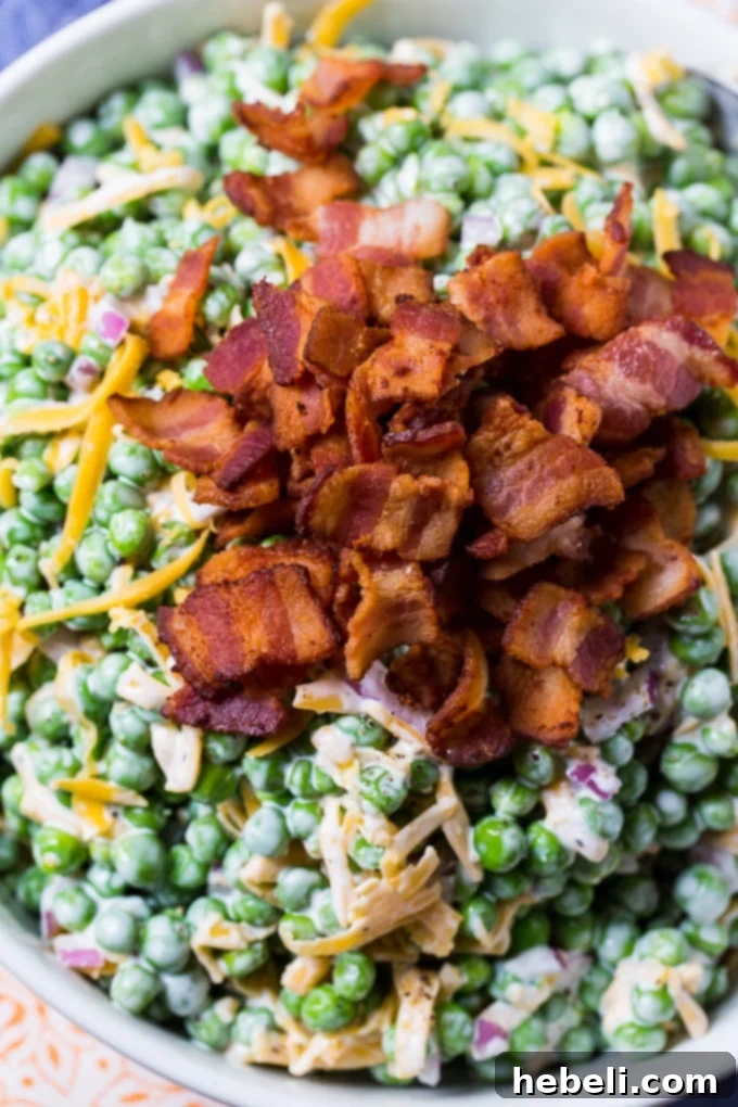 Close up of Creamy Pea Salad with visible bits of bacon and cheese.