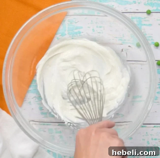 Mixing mayonnaise mixture in a bowl.