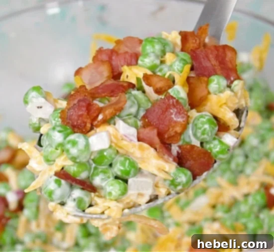Finished creamy pea salad in a serving bowl.