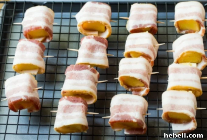 Close-up of a platter of golden-brown Spicy Bacon Wrapped Pineapple Bites, ready to be served.