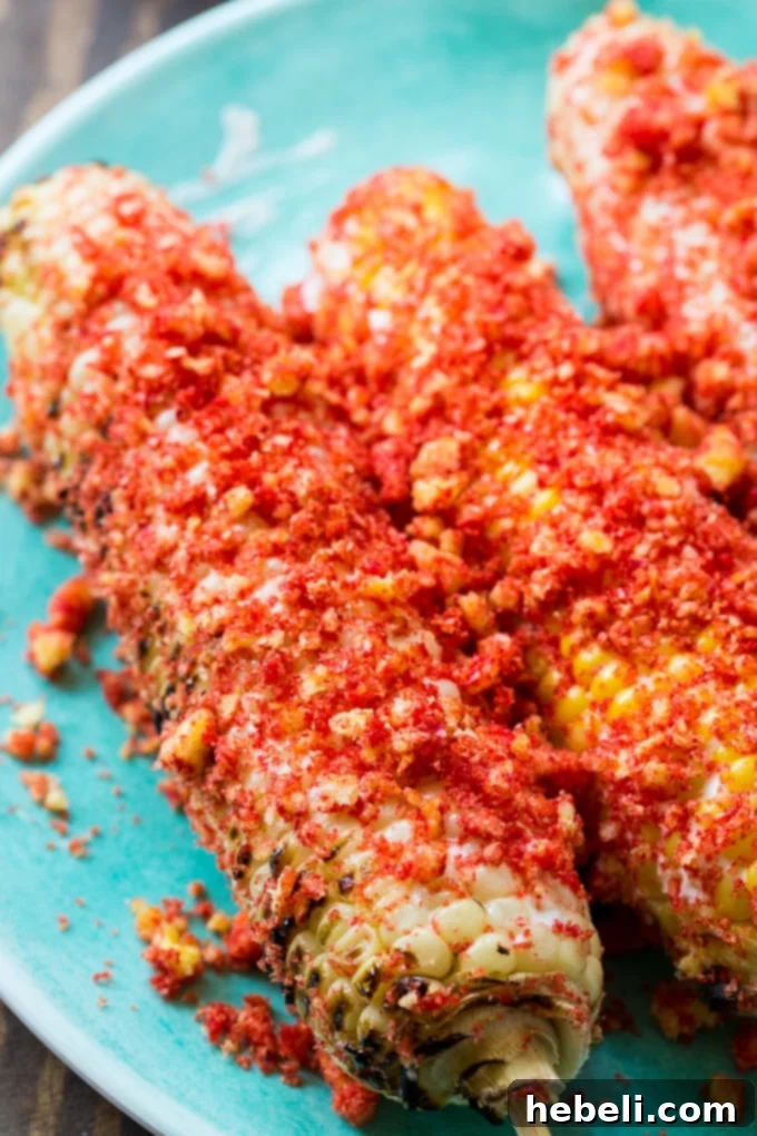 Platter of several Flamin' Hot Cheetos Corn on the Cob ears, garnished with fresh cilantro