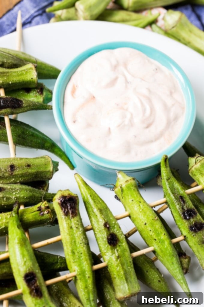 Smoky Chipotle Grilled Okra 2 Grilled Okra with Spicy Chipotle Sauce - beautifully charred whole okra pods on a platter with a side of creamy chipotle dip.