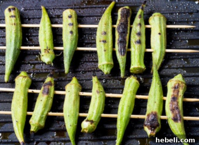 Smoky Chipotle Grilled Okra 3 Grilled Okra served with a small bowl of spicy chipotle sauce, ready to be picked up and dipped.
