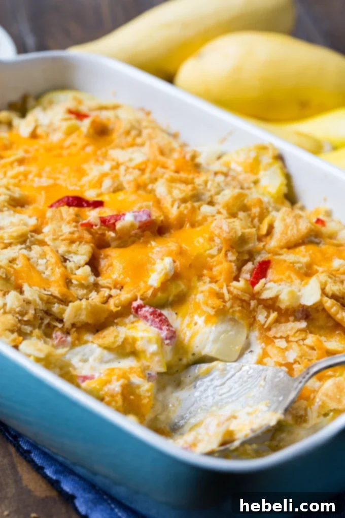 A wide shot of the Pimento Cheese Squash Casserole in a baking dish, ready to be served.
