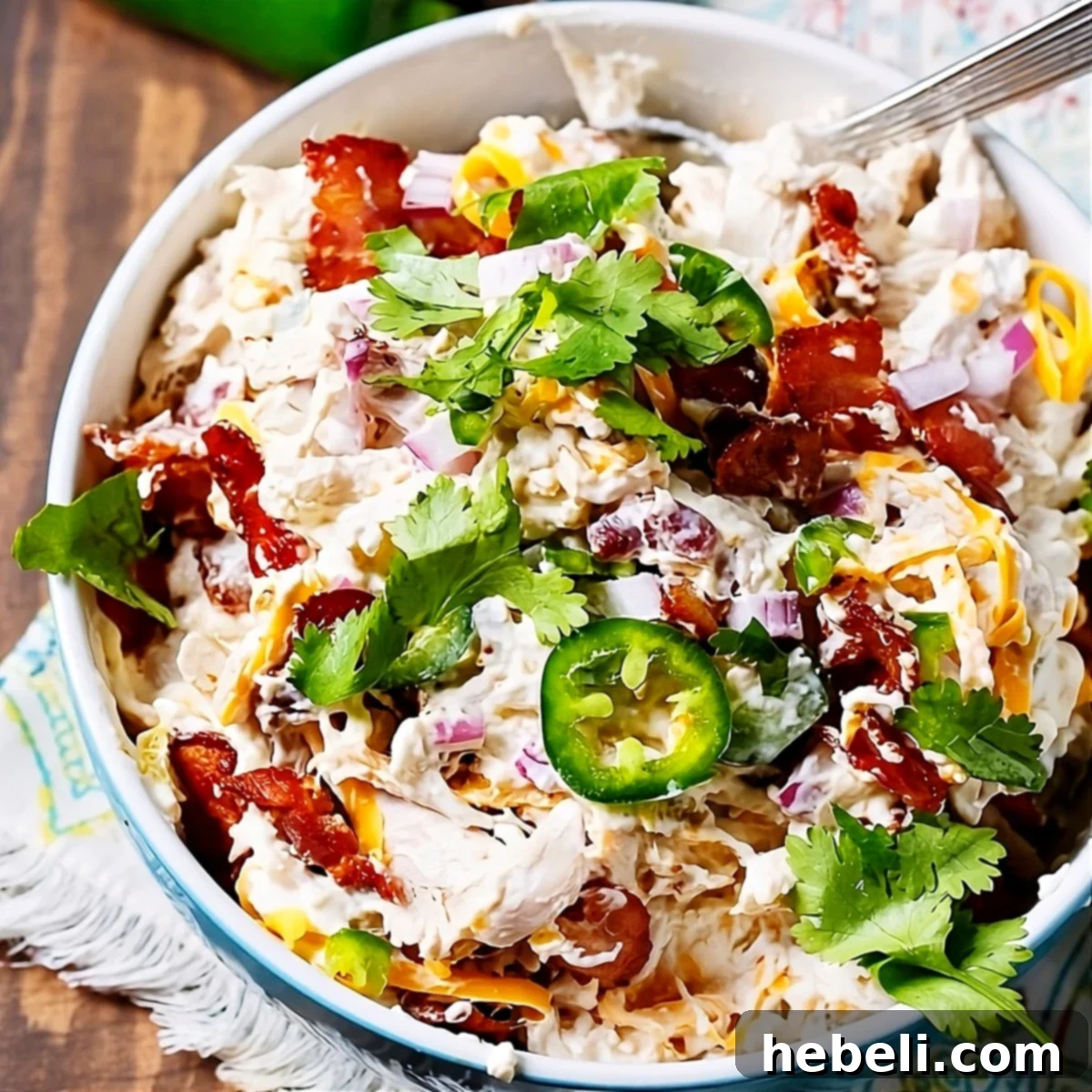 Loaded Jalapeno Popper Chicken Salad 2 Jalapeno Popper Chicken Salad in a serving bowl, showcasing its creamy texture and vibrant ingredients.