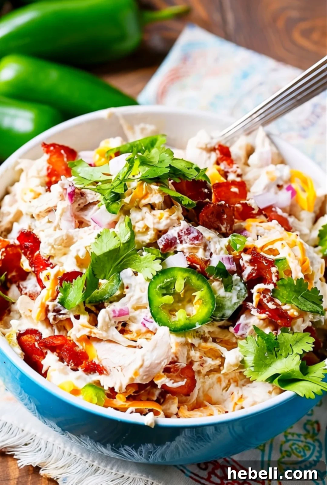 Loaded Jalapeno Popper Chicken Salad 5 Creamy Jalapeno Popper Chicken Salad garnished with fresh cilantro in a decorative serving bowl.