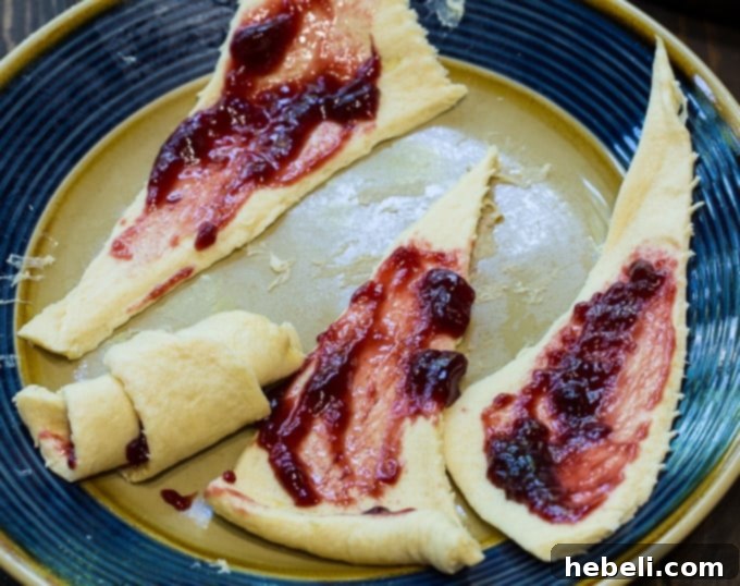 Golden Crescent Coffee Swirl 4 Serving of Crescent Roll Coffee Cake on a plate, showing the flaky layers and fruit filling.