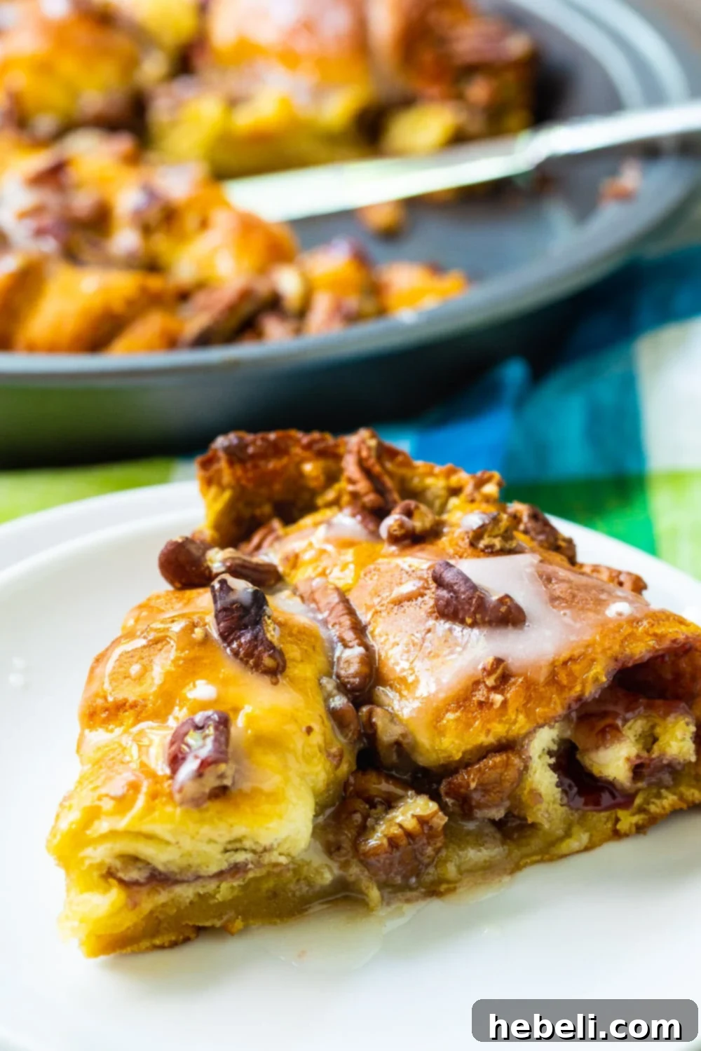 Golden Crescent Coffee Swirl 6 A perfect slice of Crescent Roll Coffee Cake on a white plate, showing the flaky crust and filling.