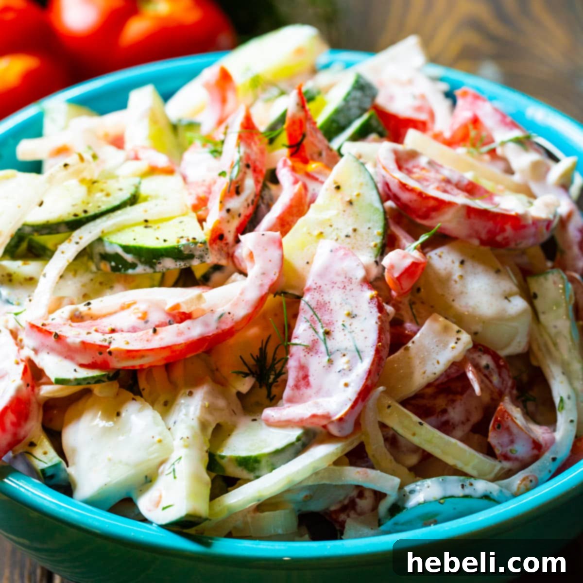 Velvet Tomato Cucumber Delight 2 Creamy Tomato and Cucumber Salad in a blue serving bowl.