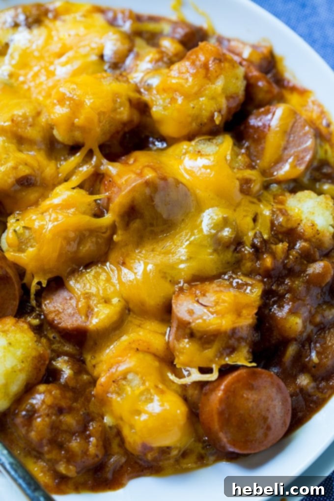 Close-up of Cheesy Hot Dog Tater Tot Casserole in a baking dish, with melted cheese.