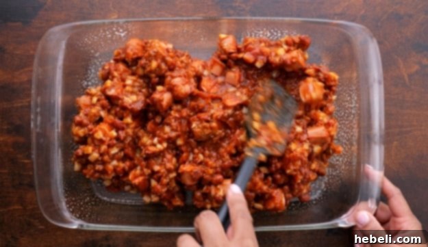 Chili mixture spread evenly in a baking pan.