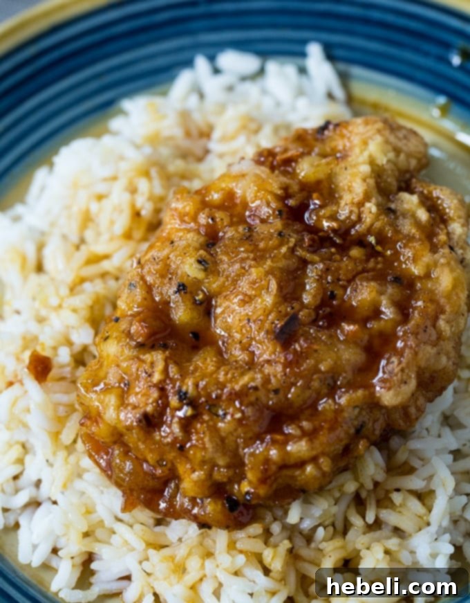Golden Crispy Honey Garlic Pork Chops 5 Close-up of a crunchy honey garlic pork chop, showcasing the crispy coating and glaze