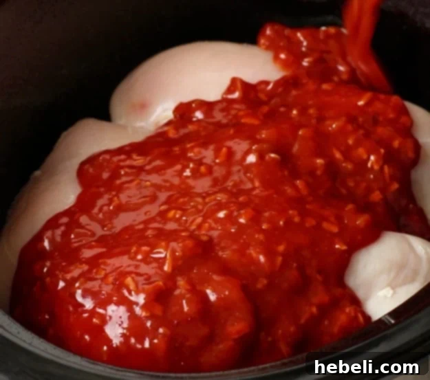 Pouring the sweet and tangy Catalina sauce over the chicken.