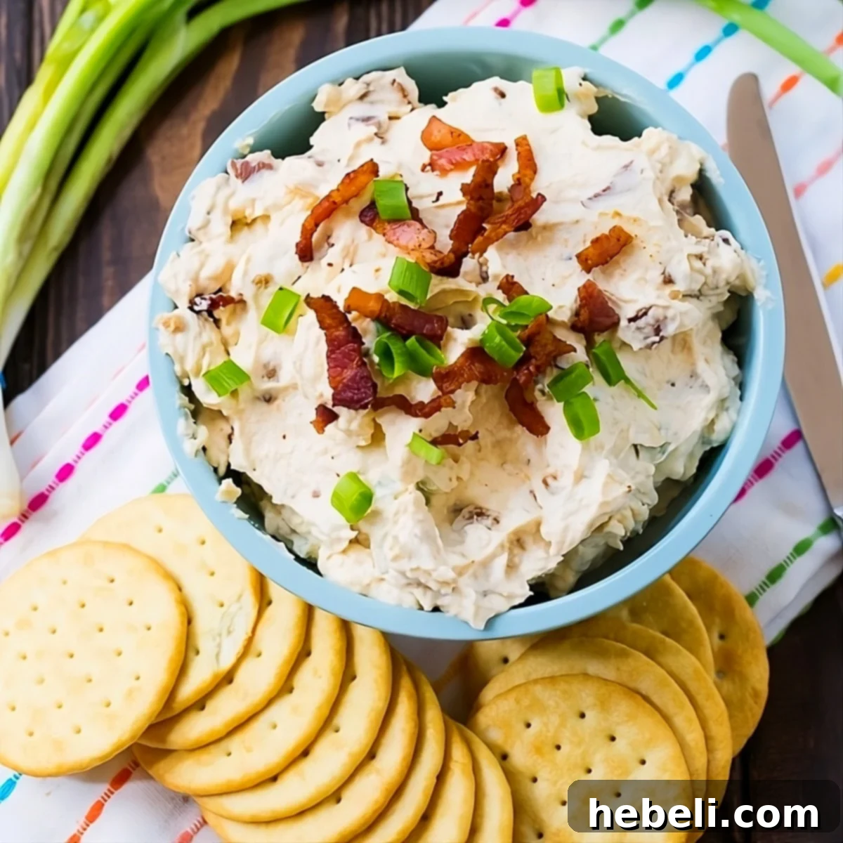 Bacon Horseradish Spread in a bowl surrounded by crackers.